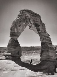 Person standing on rock formation