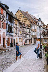 People walking on street against buildings in city