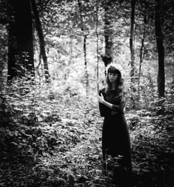 Woman standing in forest