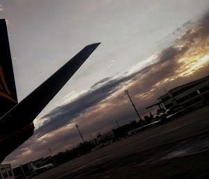 Airplane against sky at dusk