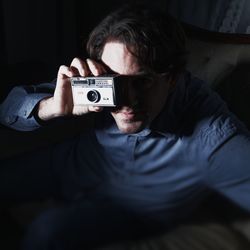 Portrait of young man photographing