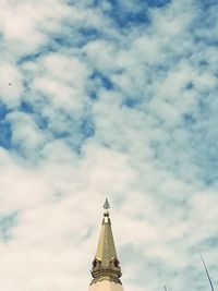 Low angle view of a building against cloudy sky
