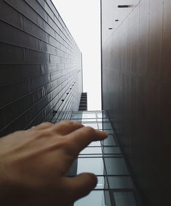 Person hand on building wall