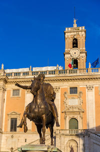 Low angle view of statue against building