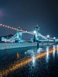 Illuminated bridge at night