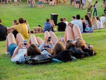 Group of people relaxing on field