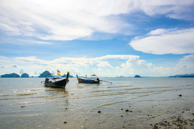 Boats moored on sea against sky