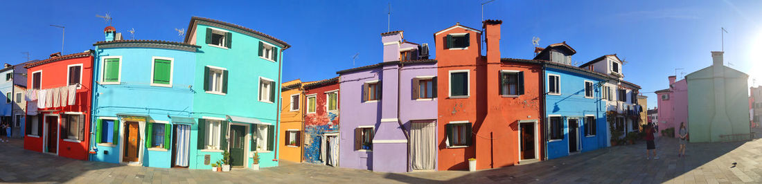 Multi colored buildings against blue sky