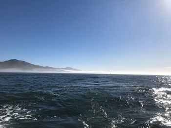 Scenic view of sea against clear blue sky