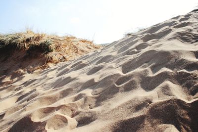 Close-up of sand dune in desert against clear sky