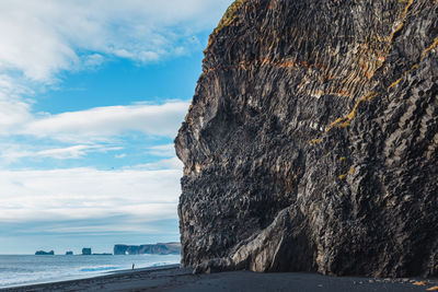 Rock formations by sea against sky