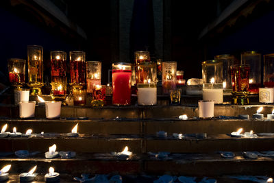 Illuminated candles on building at night