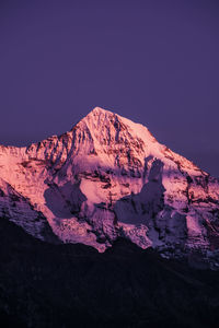 Scenic view of snowcapped mountains against clear sky