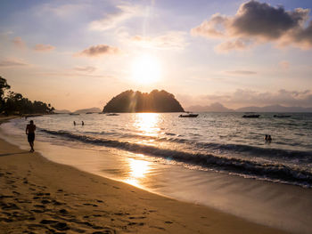 Scenic view of beach against sky during sunset