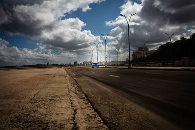 Road by city against sky