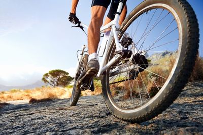 Low section of man riding bicycle