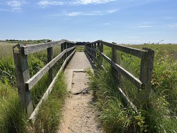 Beautiful landscape with wood bridge over water at nature reserve by the beach  walberswick suffolk 