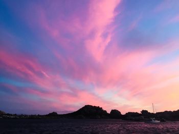 Scenic view of sea against romantic sky at sunset