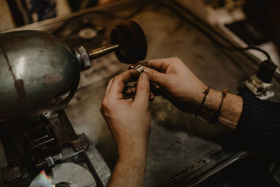 Midsection of person working on barbecue grill