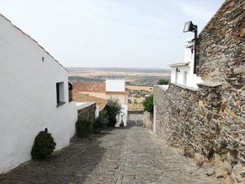 Houses by plants against sky