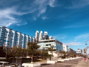 Buildings in city against blue sky