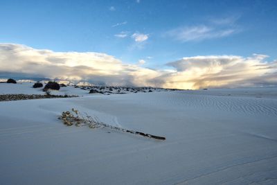 Scenic view of snow covered land against sky