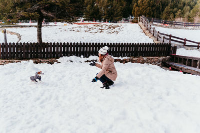 Boy on snow covered field during winter