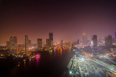 High angle view of illuminated cityscape against clear sky