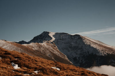 Scenic view of snowcapped mountains against clear sky