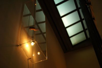 Low angle view of illuminated lamp at home