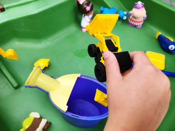 High angle view of baby playing with toy