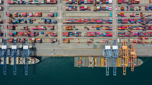 Aerial view of multi colored cargo container by lake