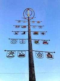 Low angle view of street light against blue sky