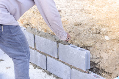 Low section of man standing on concrete