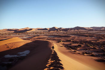 High angle view of person on sand dune at namib desert against clear sky