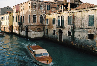 High angle view of canal amidst buildings