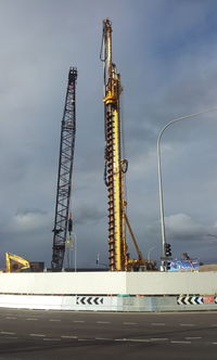 Construction site against cloudy sky