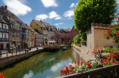 Canal amidst buildings against sky