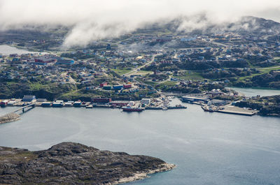 Aerial view of city against cloudy sky