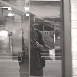 Man standing by train window at railroad station