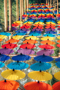 Low angle view of multi colored umbrellas hanging on clothesline