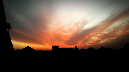 Silhouette of built structure at sunset