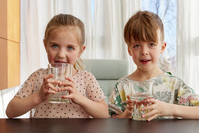 Portrait of cute girl drinking glass