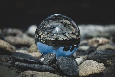 Close-up of crystal ball on rock