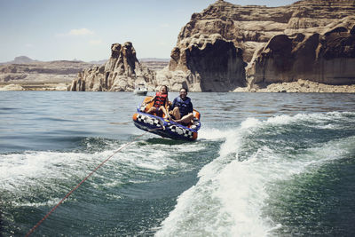 People on rock in sea