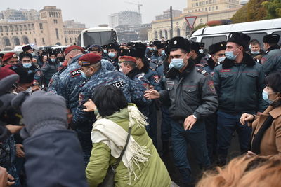 Rear view of people standing in city