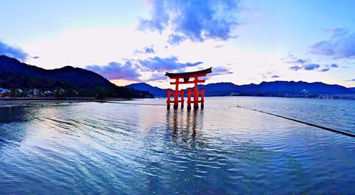 Scenic view of lake against cloudy sky