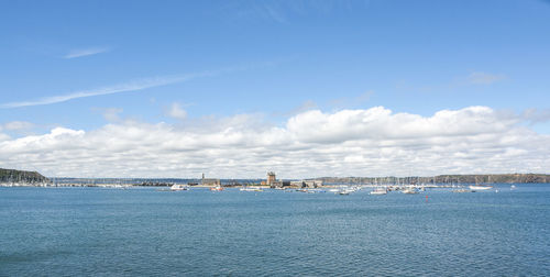 Scenic view of sea by buildings against sky