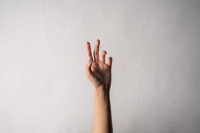 Close-up of woman hand against white background