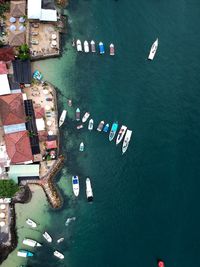Drone view of boats moored on sea